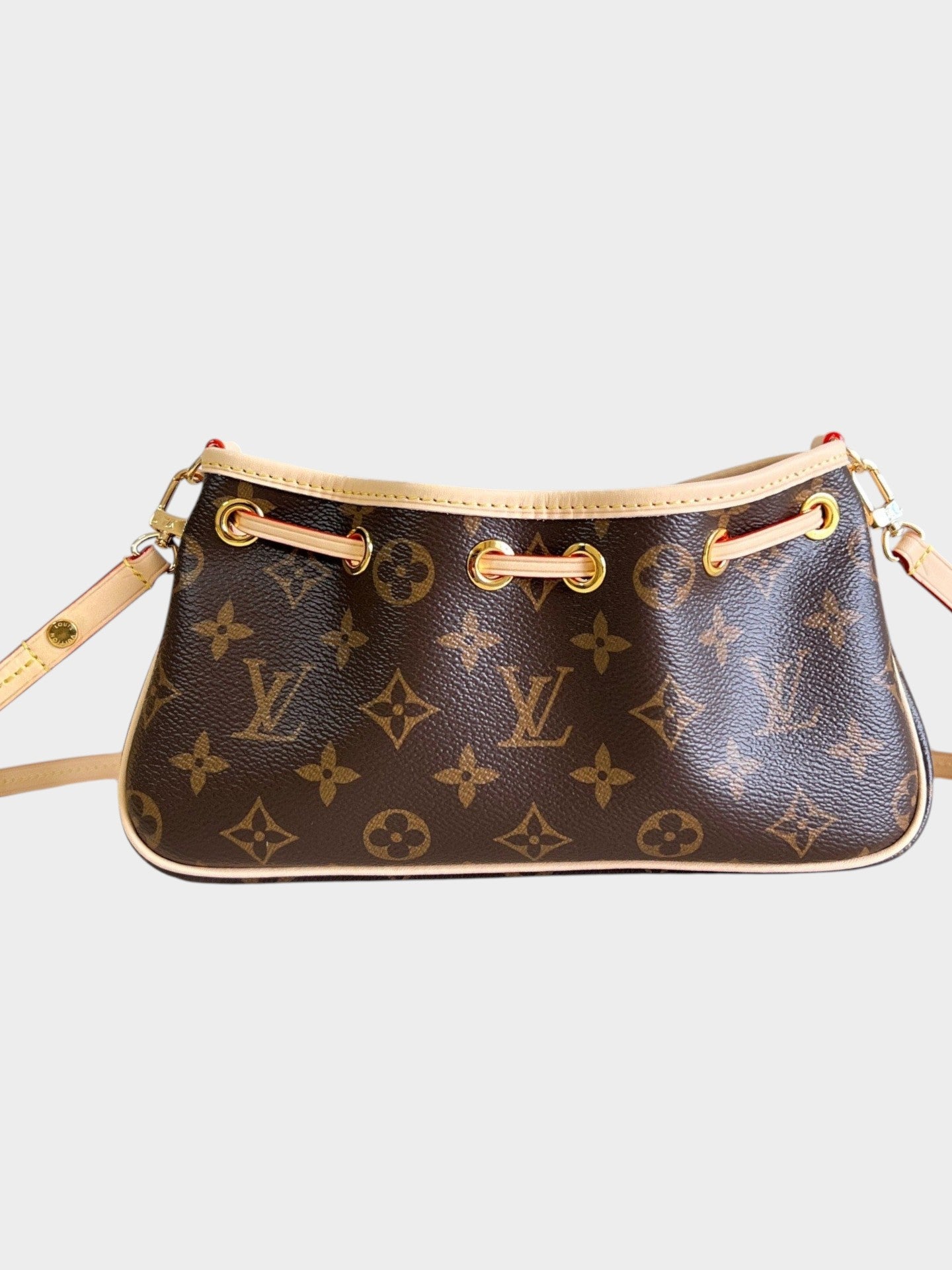 Zebass Louis Vuitton monogram coated canvas drawstring shoulder bag with light leather trim and gold-tone hardware.