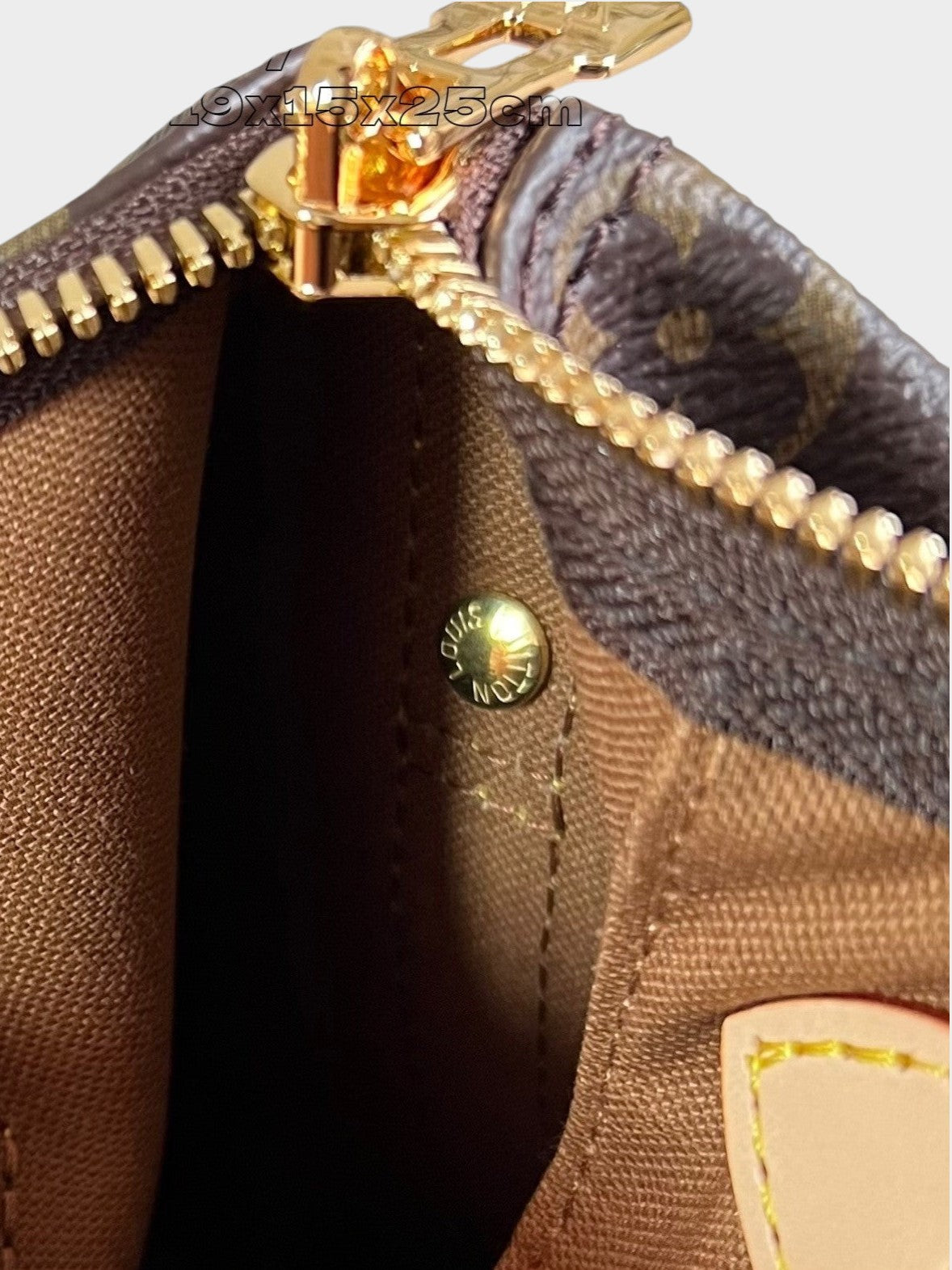 Zebass Louis Vuitton monogram canvas satchel interior featuring gold-tone hardware, zip closure, and branded rivet.