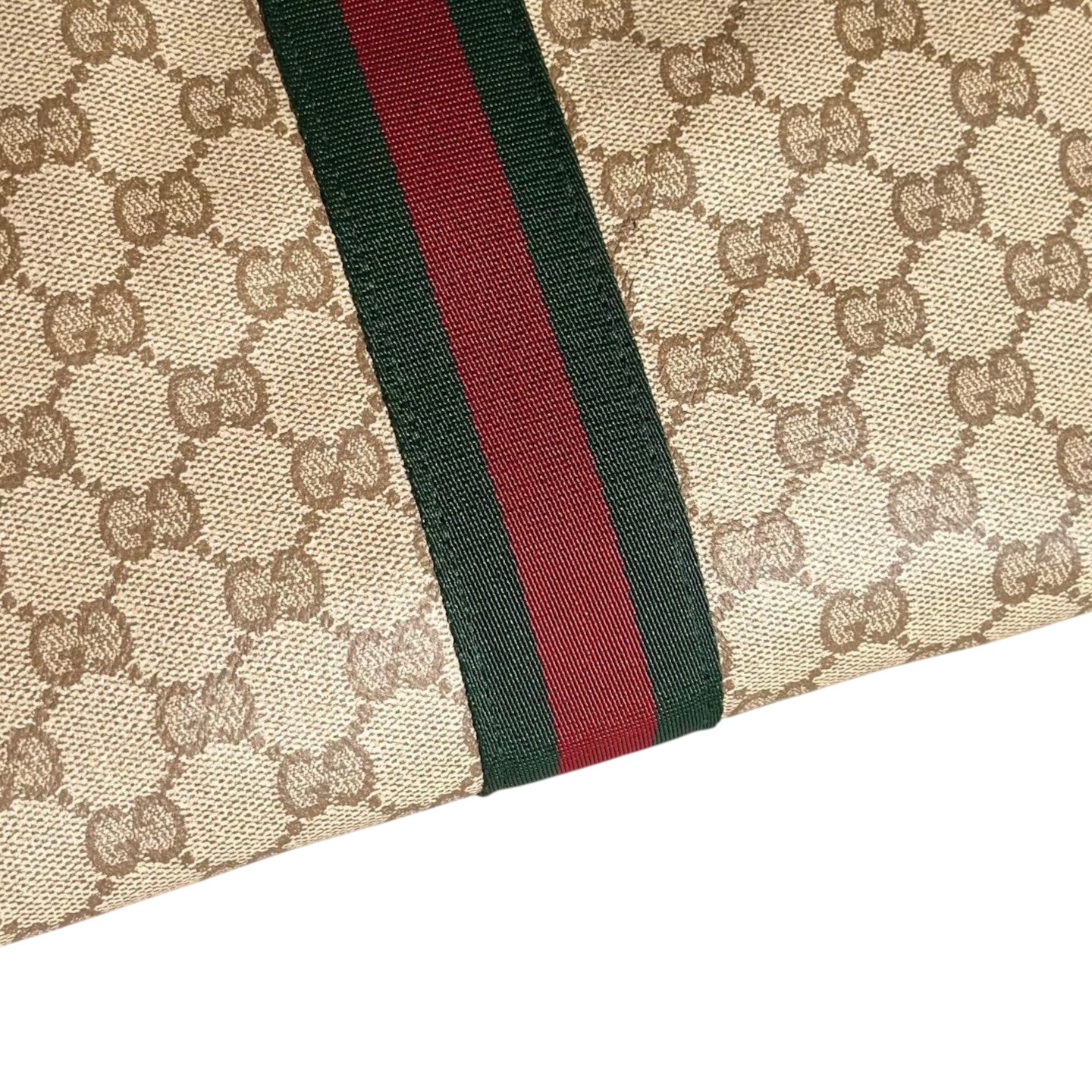 Zebass Gucci monogram canvas wristlet pouch featuring the iconic green and red Web stripe detail on beige fabric.