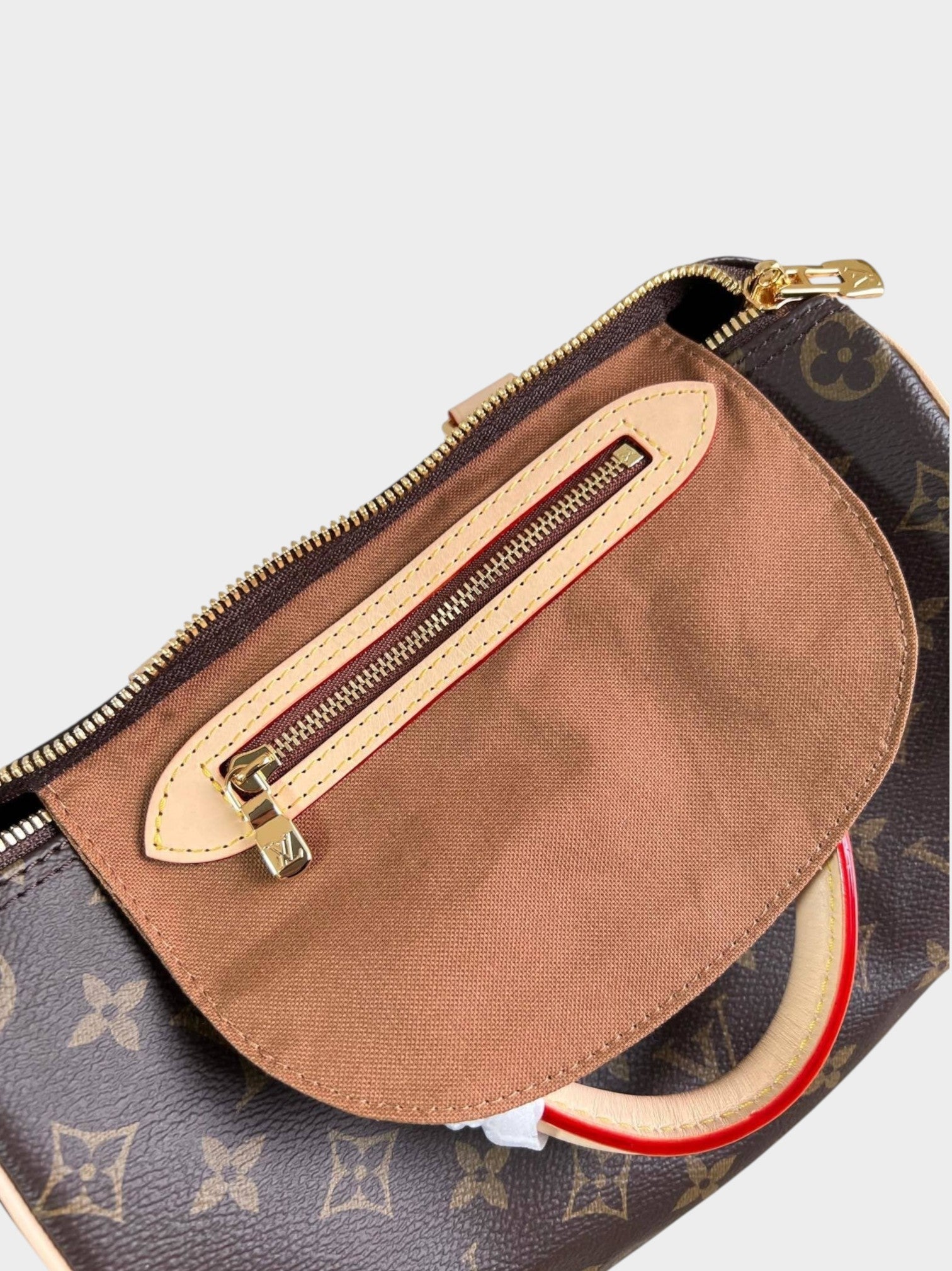Zebass Louis Vuitton monogram canvas satchel bag interior view with brown fabric lining and gold zip pocket