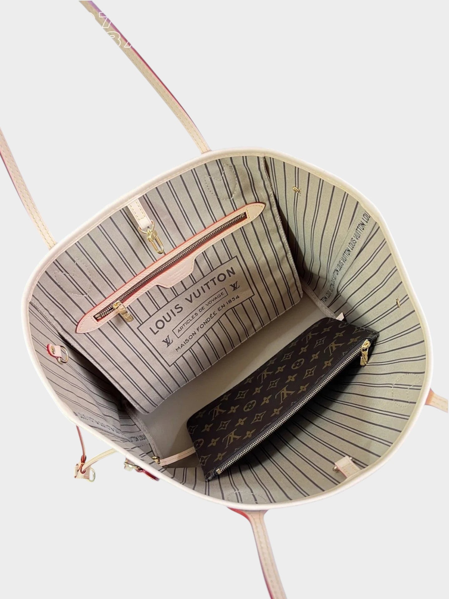 Zebass LOUIS VUITTON Neverfull tote interior with striped lining, monogram pouch, and gold-tone hardware details.